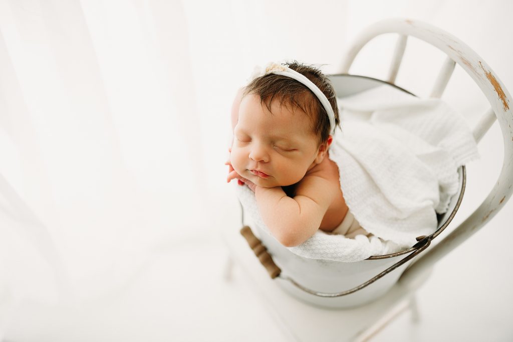 Best Newborn Photographer near me Baby in bucket by window