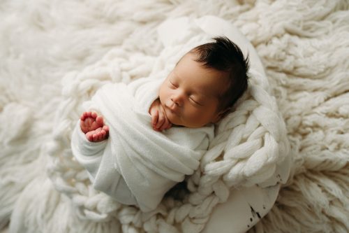 Boy swaddled for newborn photo
