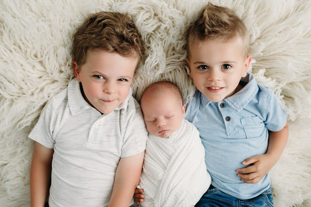 proud brothers welcome newborn baby
