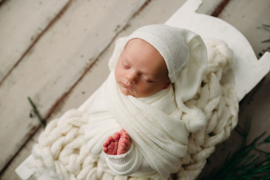 newborn boy in sleepy cap