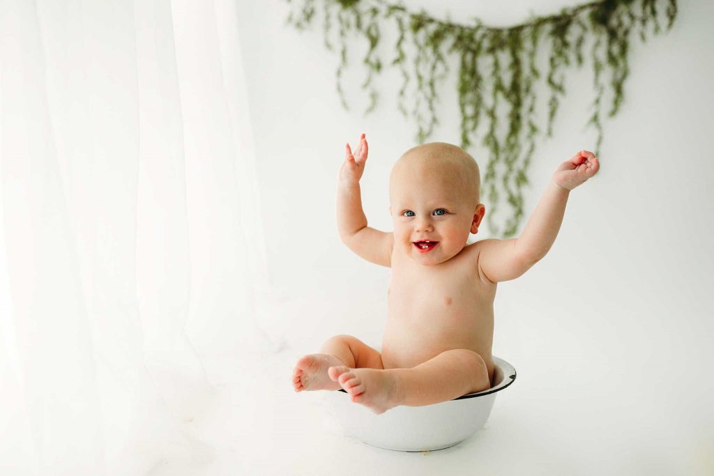excited baby boy splash bath