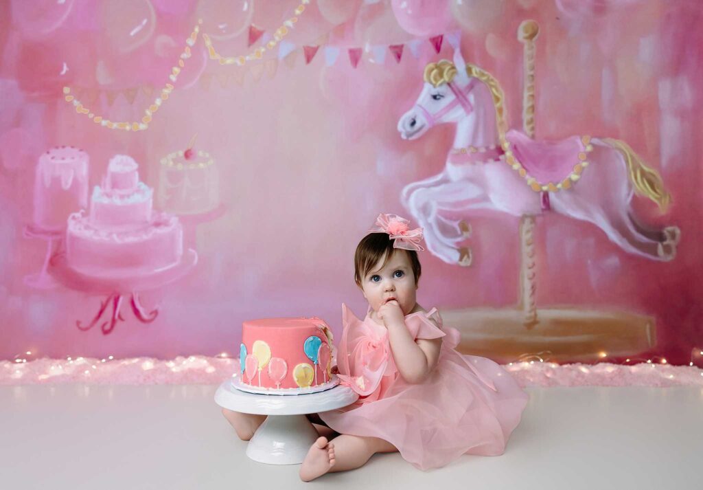 baby eating pink cake