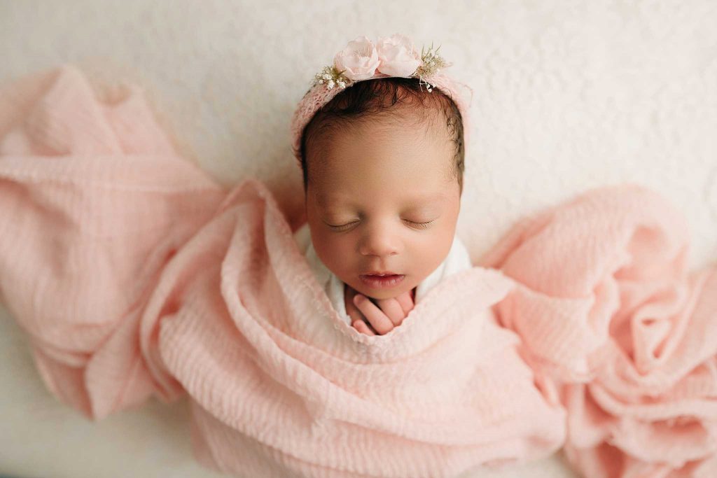 newborn infant in pink holly marie photography