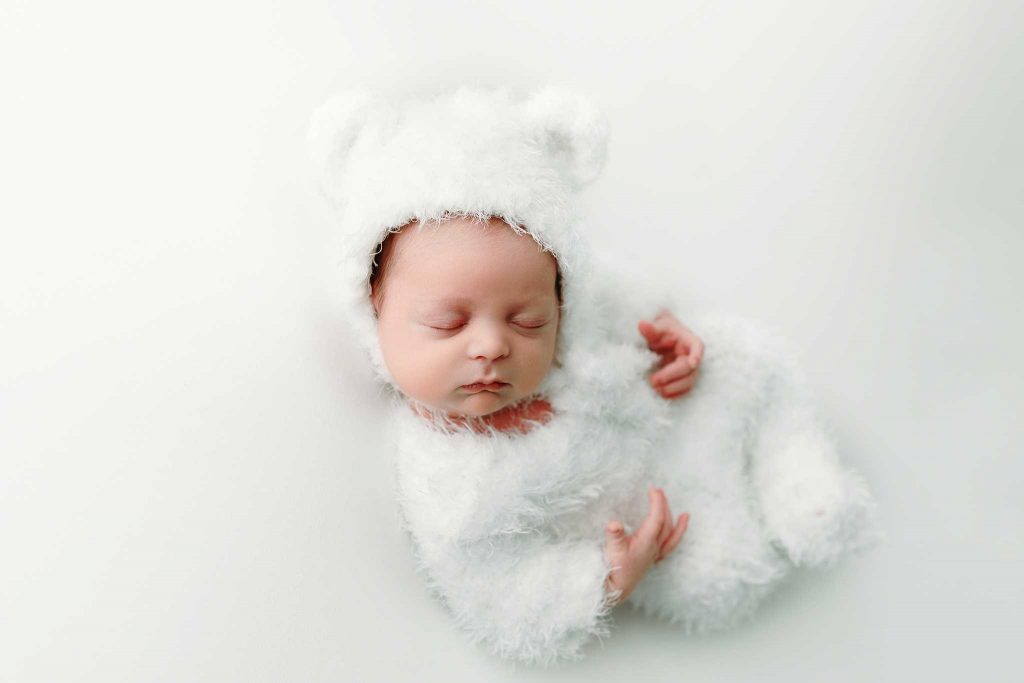 newborn in fuzzy bear outfit
