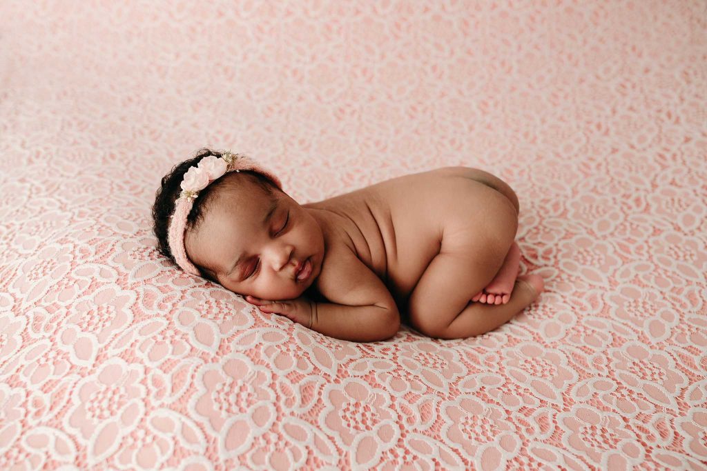 newborn girl bum up on floral backdrop