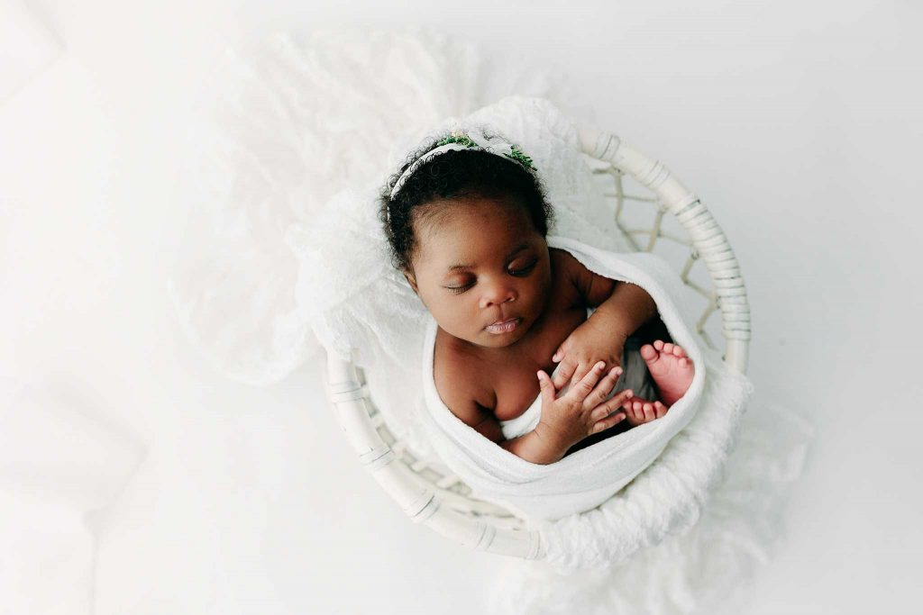 Black newborn sleeping at holly marie photography newborn photo session