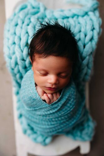 newborn boy in trench bowl teal