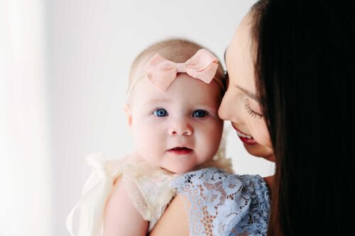 mom in blue dress baby girl white dress