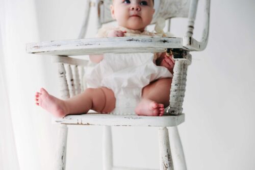 baby in antique high chair