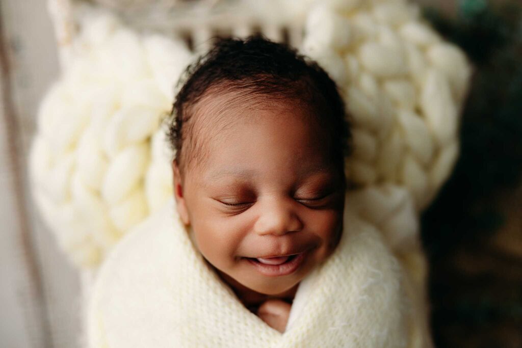 baby in basket smile