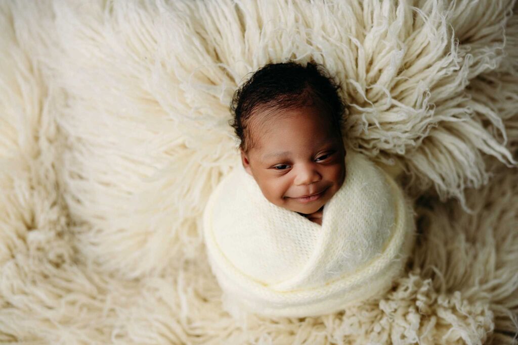baby in yellow wrap fur blanket