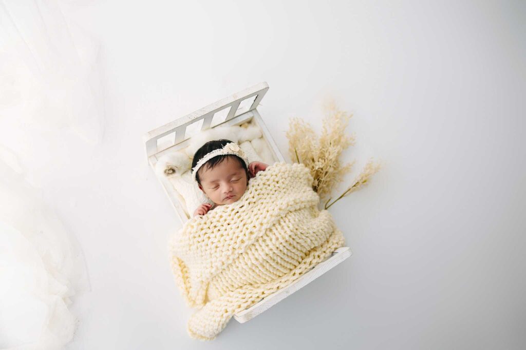 newborn cream bed
