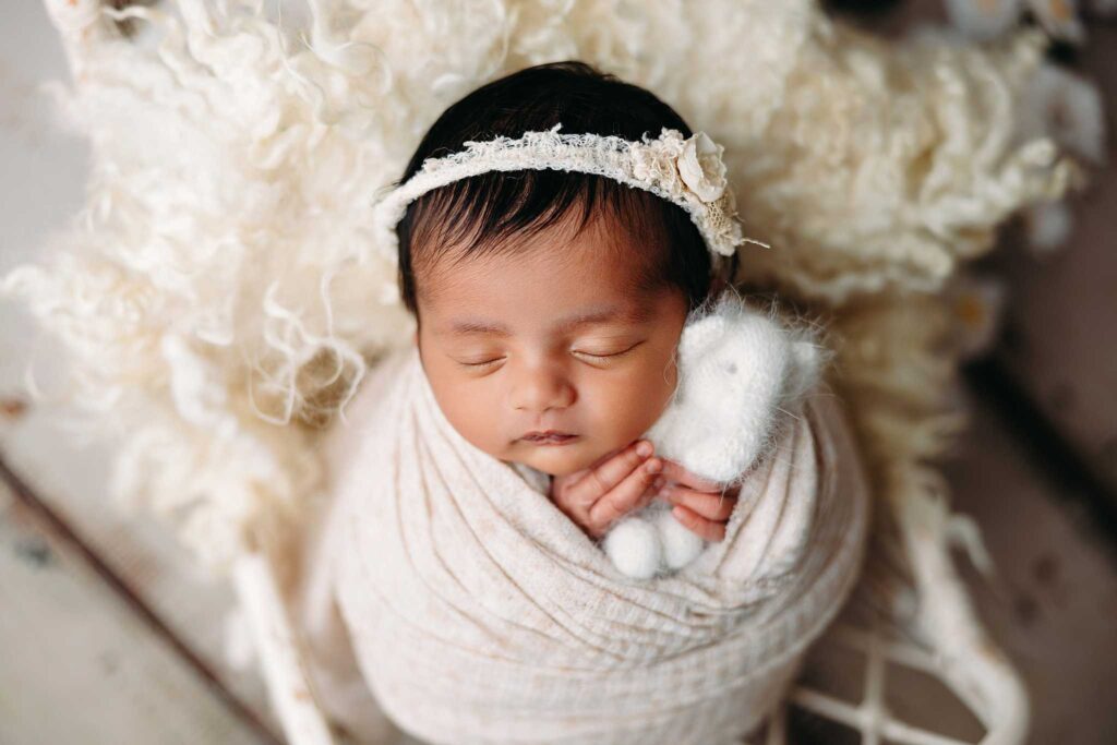newborn wrapped cream sheep fur basket white elephant