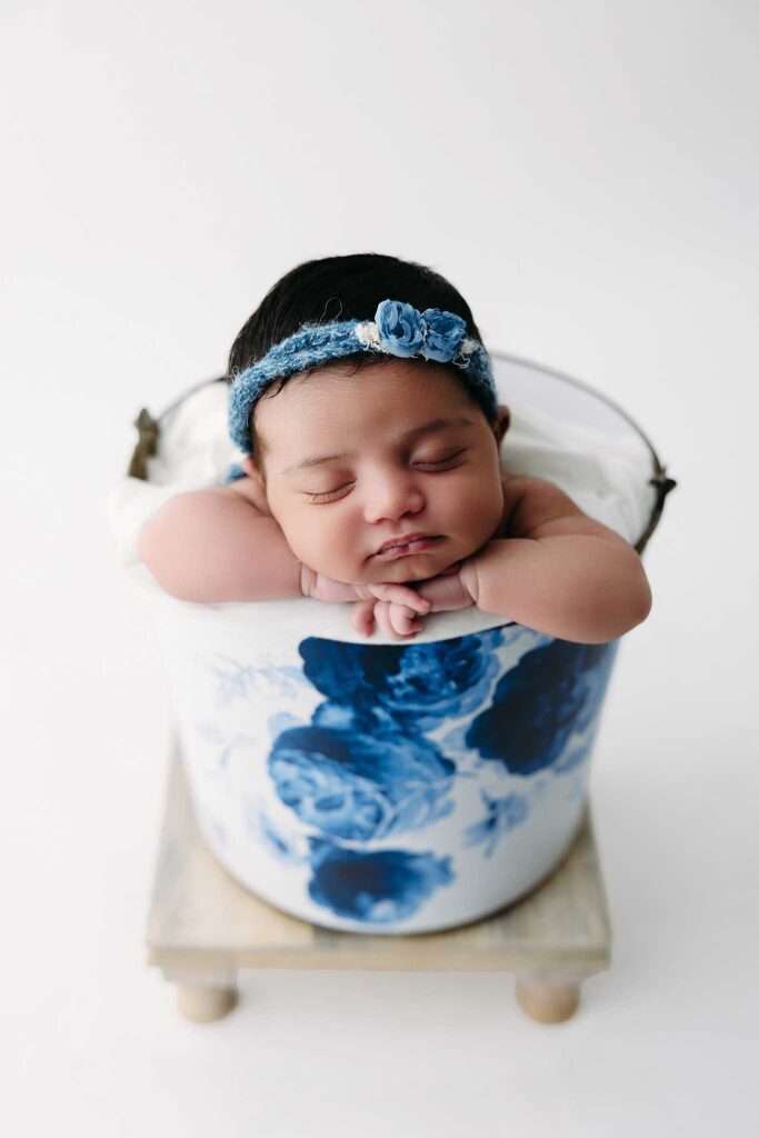 baby in bucket with blue tieback