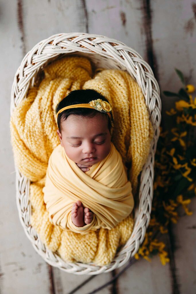baby wrapped in bassinet
