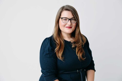 sophisticated woman blue dress glasses red lip