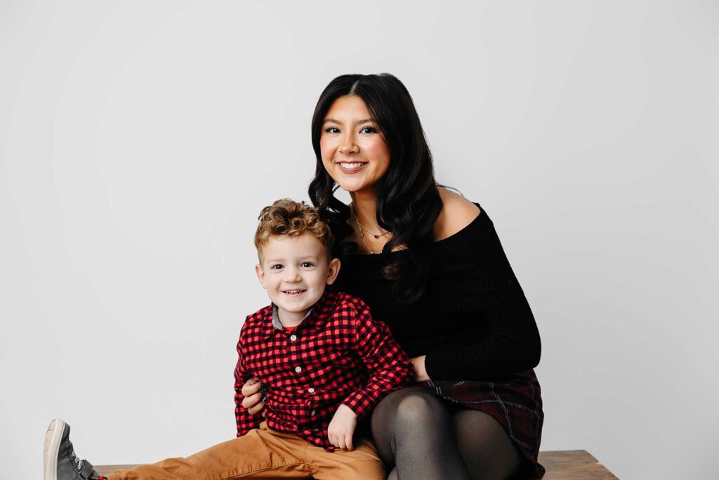 boy red checked shirt sitting on bench sister